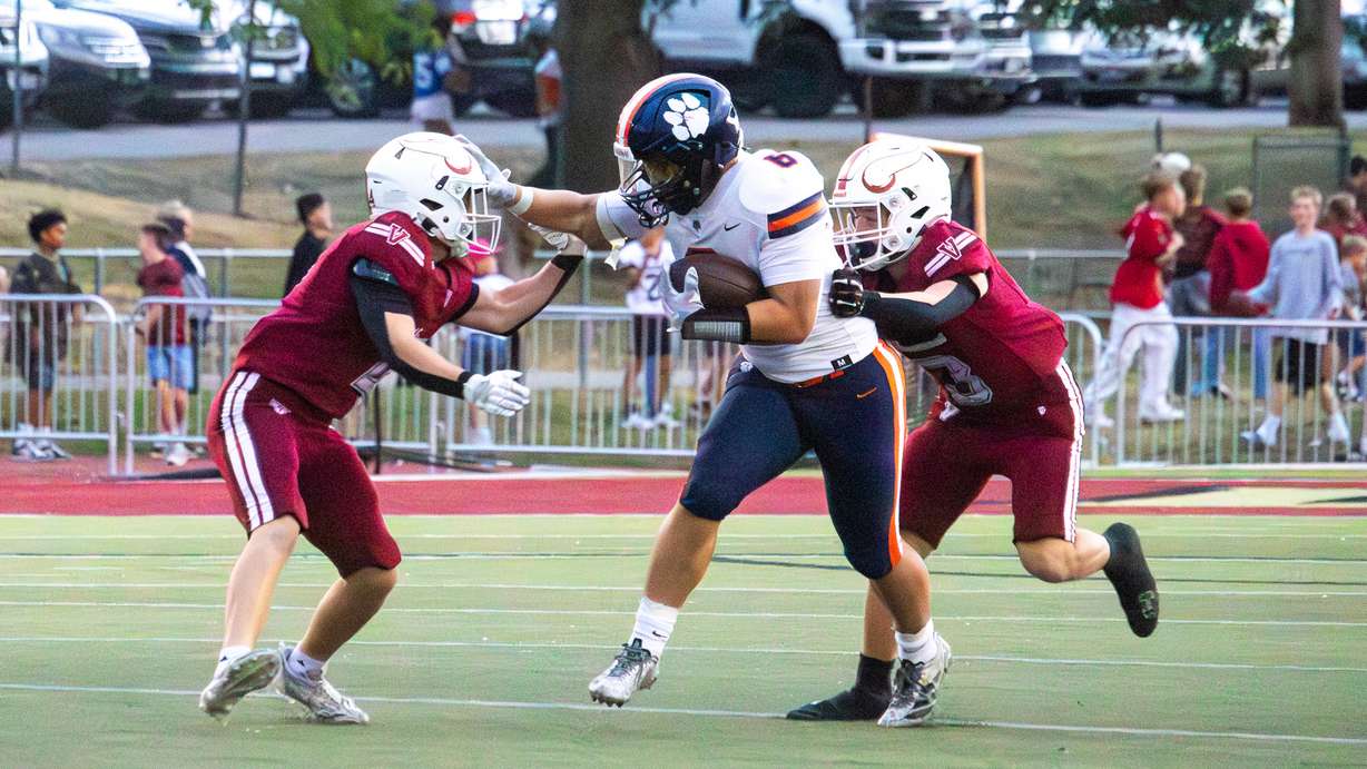 Brighton running back Staton Gutierrez stiff-arms a Viewmont defender during a game at Viewmont High on Sept. 19, 2025.