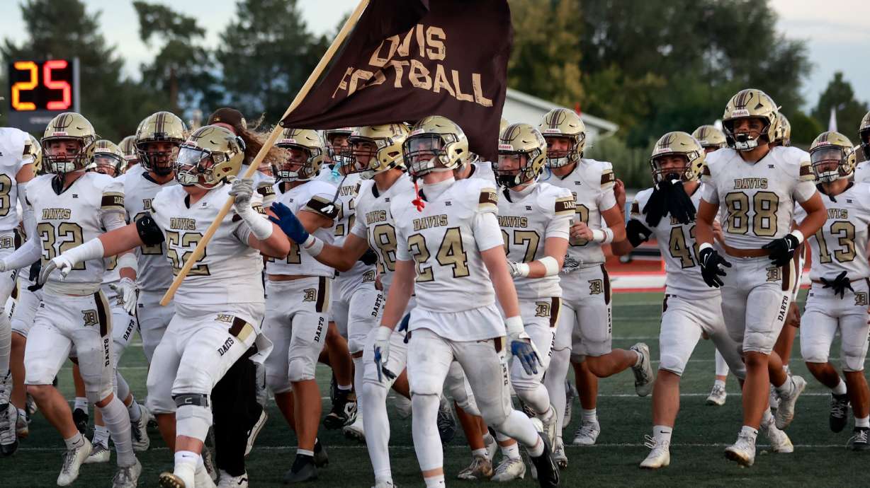 Davis Darts rush the field before playing American Fork in a varsity football game at American Fork High School in American Fork on Friday, Sept. 19, 2025.