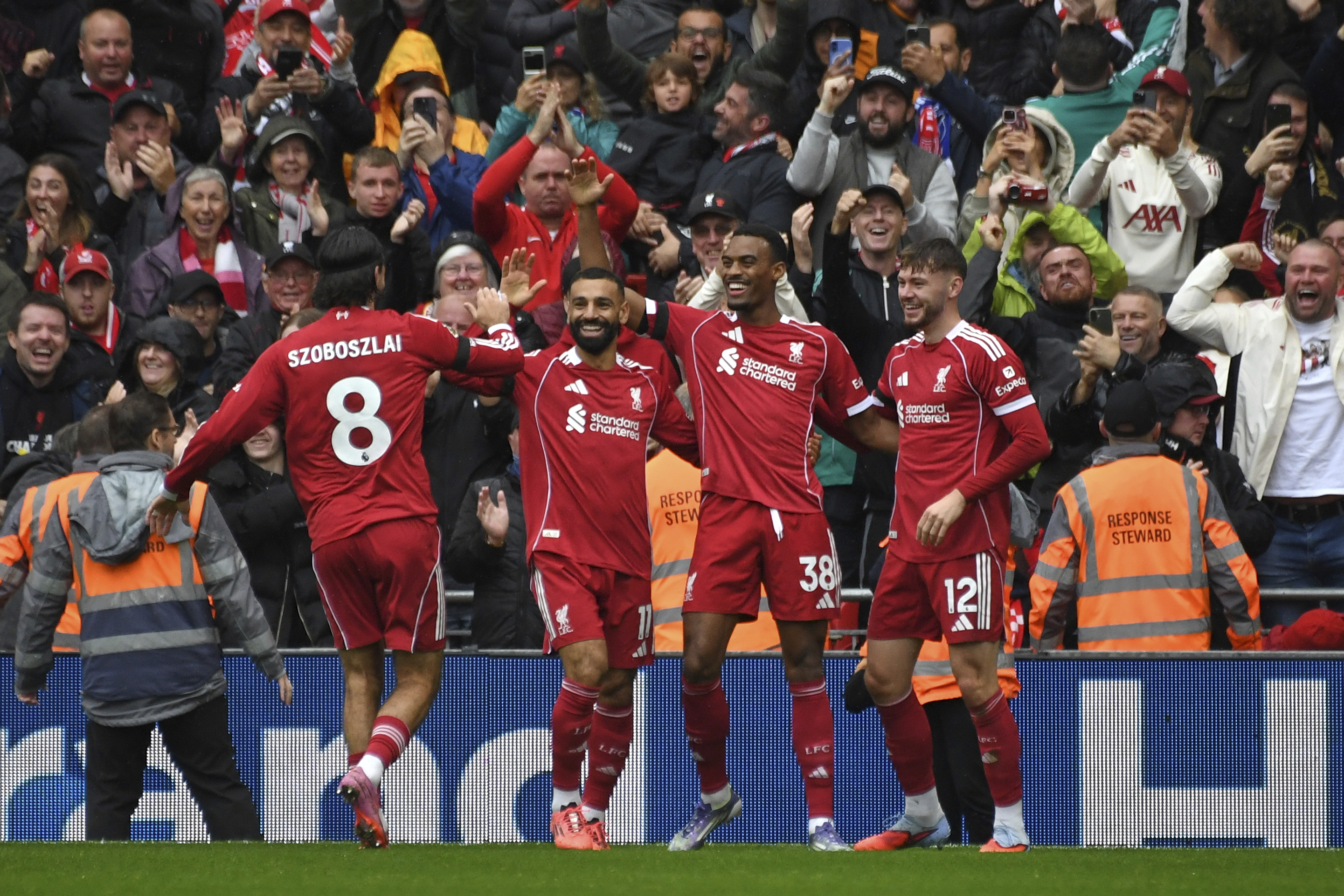 Liverpool's Ryan Gravenberch, second right, celebrates with teammates after scoring his side's opening goal during the English Premier League soccer match between Liverpool and Everton at Anfield stadium in Liverpool, England, Saturday, Sept. 20, 2025.
