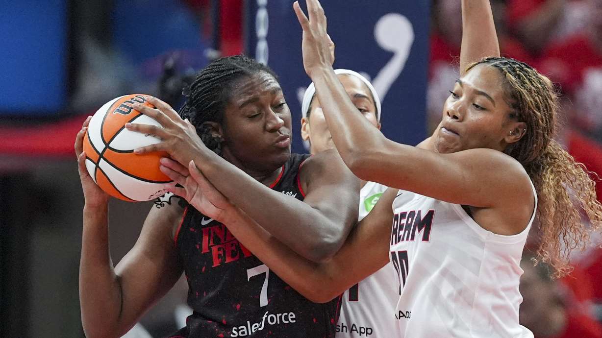 Indiana Fever forward Aliyah Boston (7) get tied up with Atlanta Dream forward Naz Hillmon (0) in the first half of a WNBA basketball playoff game in Indianapolis, Tuesday, Sept. 16, 2025.