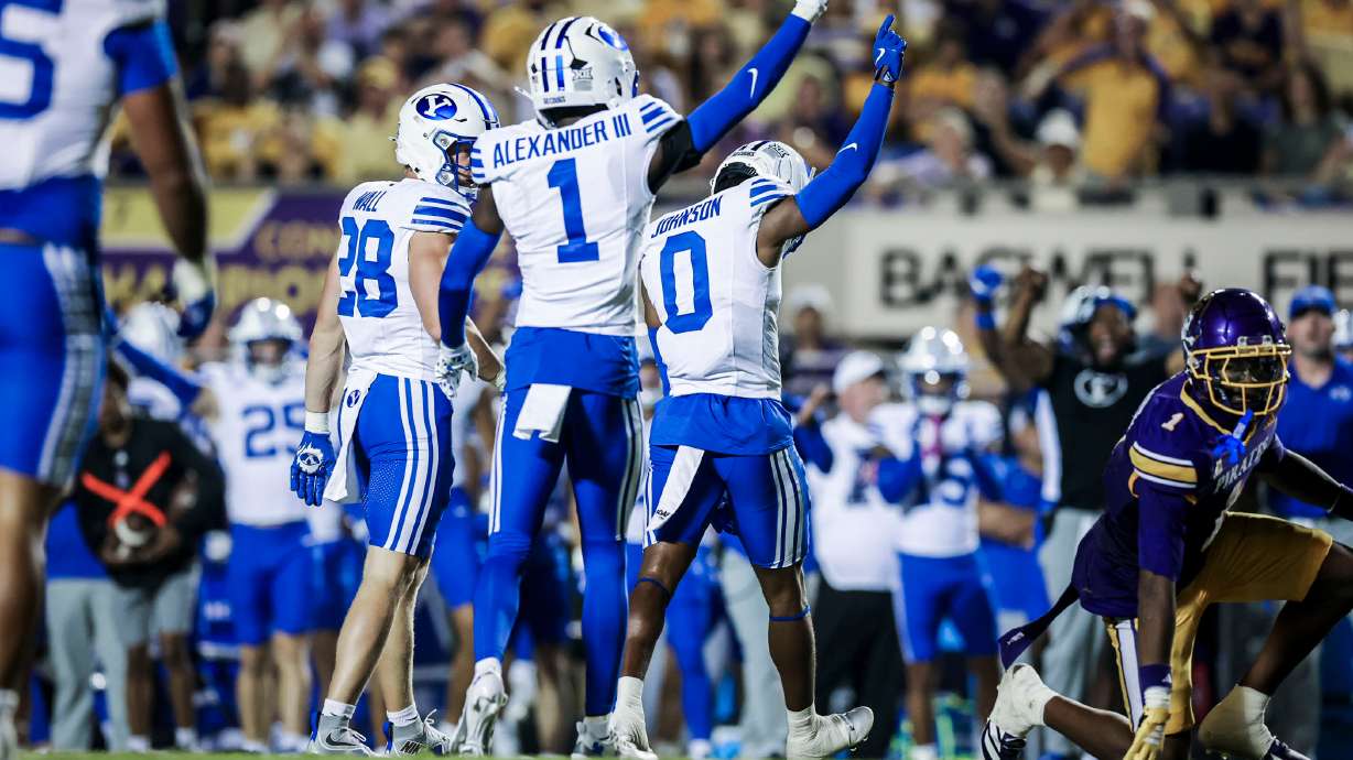 BYU cornerbacks Tre Alexander (1) and Evan Johnson (0) celebrate a play during an NCAA college football game against East Carolina, Saturday, Sept. 20, 2025 in Greenville, N.C.