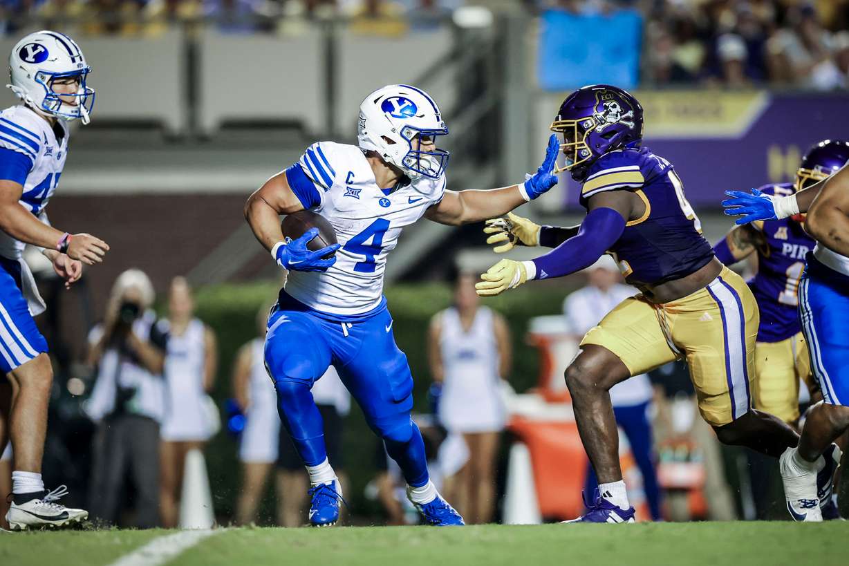 BYU running back LJ Martin stiff-arms a defender during an NCAA college football game against East Carolina, Saturday, Sept. 20, 2025 in Greenville, N.C.