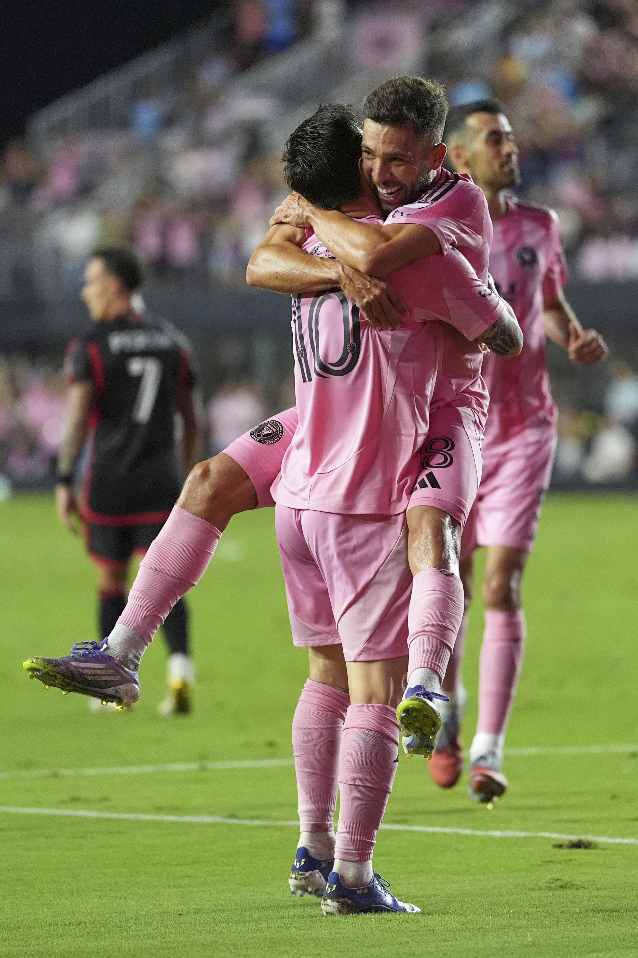 Inter Miami forward Lionel Messi (10) lifts defender Jordi Alba as he celebrates scoring his side's second goal against D.C. United during the second half of an MLS soccer match, Saturday, Sept. 20, 2025, in Fort Lauderdale, Fla. 