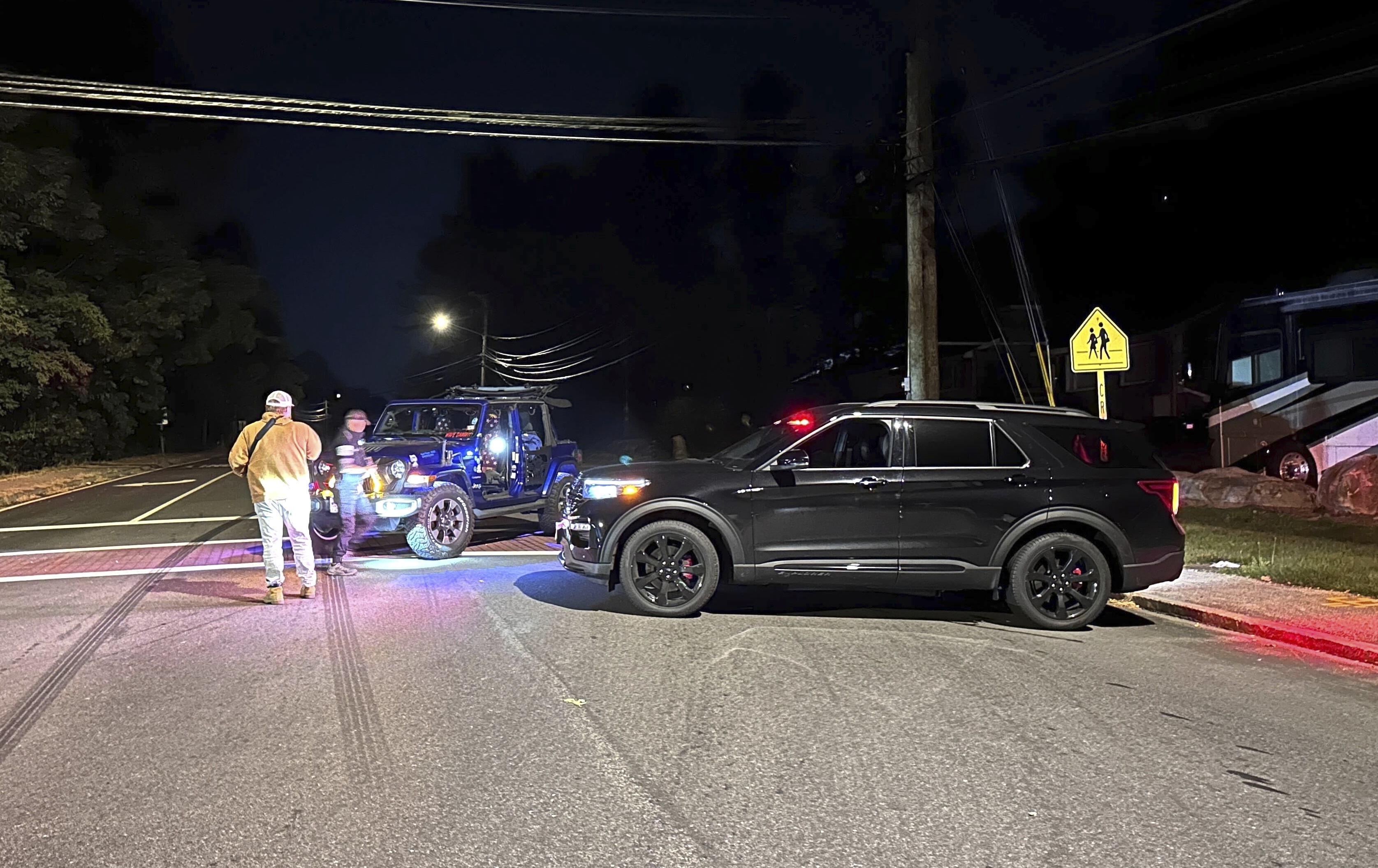 Police block a road to a country club where a shooting happened at Sky Meadow Country Club in Nashua, New Hampshire, Saturday. Police said there was one person dead and "several people" wounded, and a suspect is in custody.