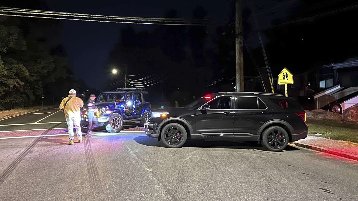 Police block a road to a country club where a shooting happened at Sky Meadow Country Club in Nashua, New Hampshire, Saturday. Police said there was one person dead and "several people" wounded, and a suspect is in custody.
