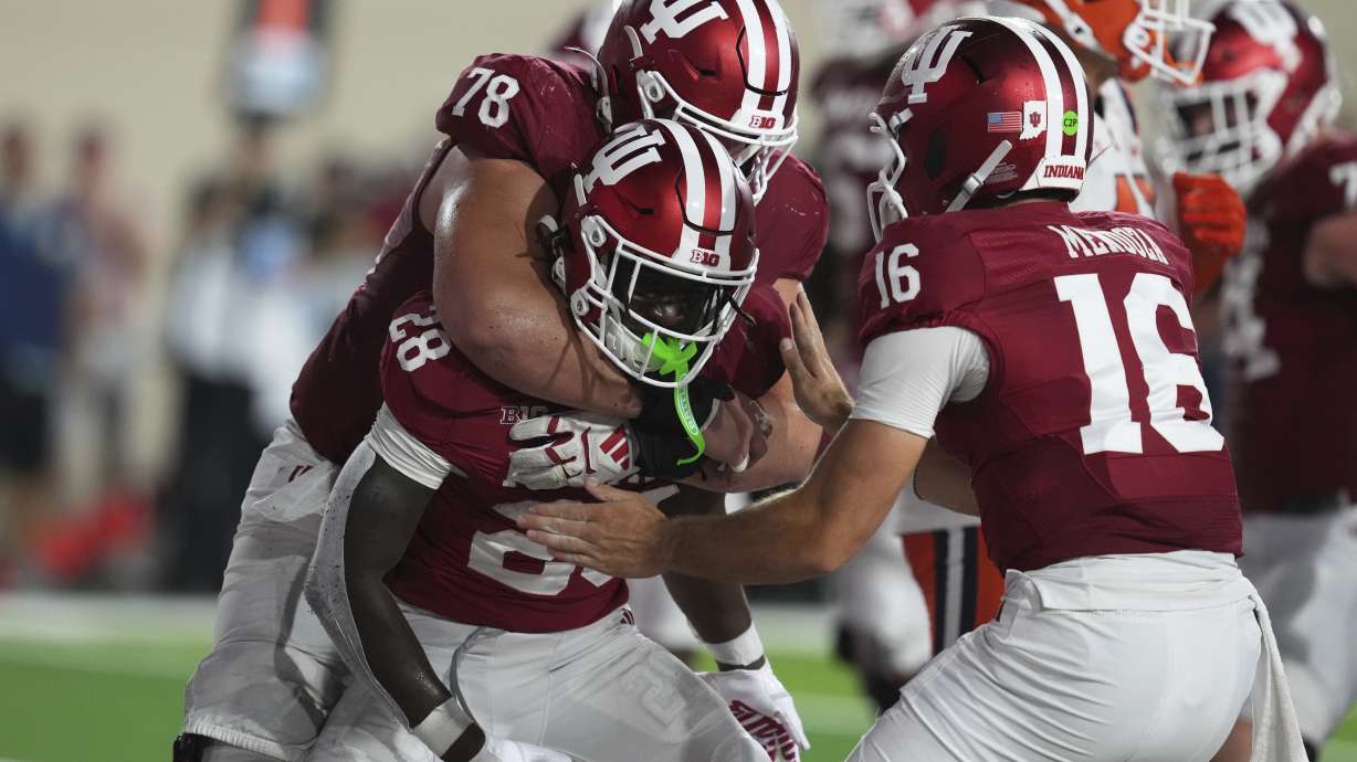 Indiana running back Khobie Martin (28) celebrates a touchdown run with offensive lineman Pat Coogan (78) and quarterback Alberto Mendoza during the second half of an NCAA college football game, Saturday, Sept. 20, 2025, in Bloomington, Ind.