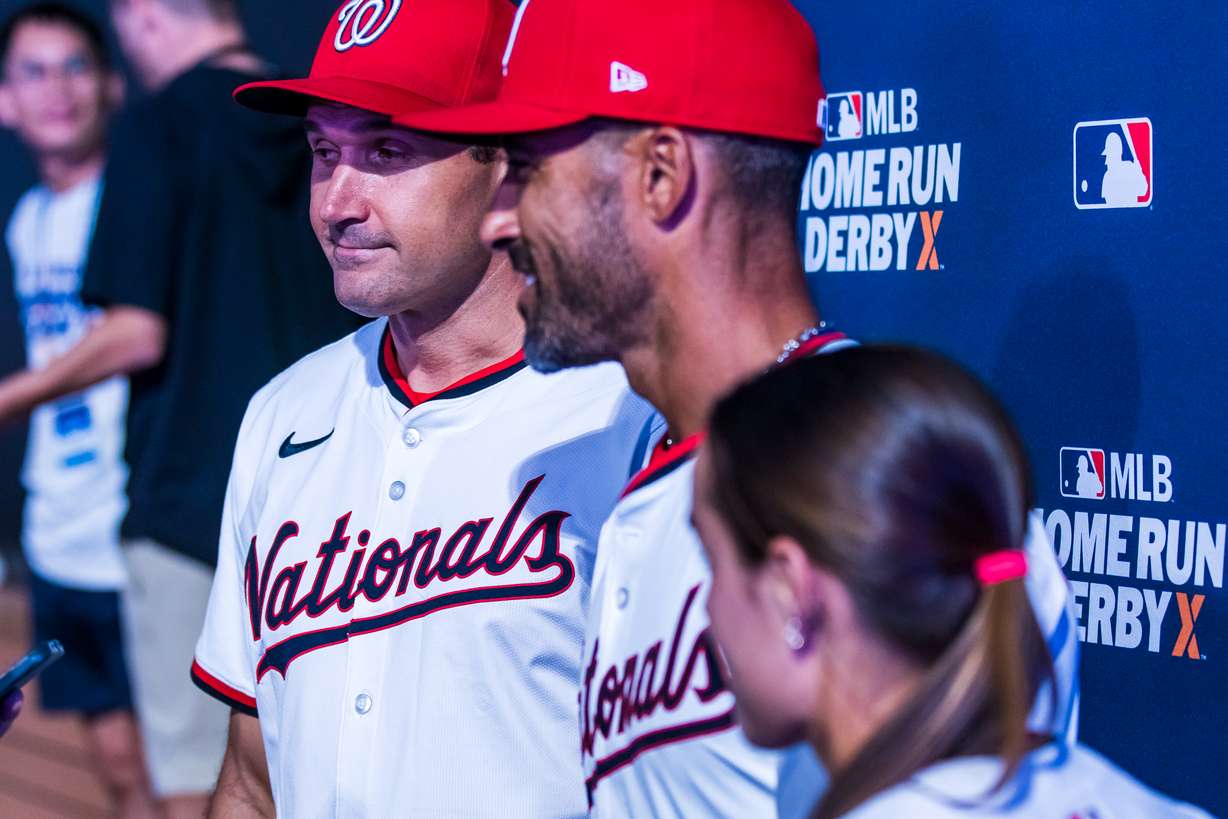 Ryan Zimmerman, left, Ian Desmond, center, and Ali Newland, right, answer questions in dugout after winning a quarterfinal matchup of Home Run Derby X at The Ballpark at America First Square on Friday.
