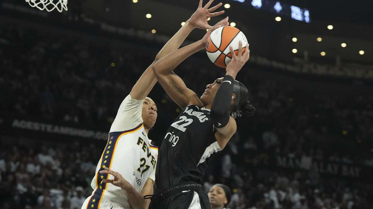 Las Vegas Aces center A'ja Wilson (22) looks to shoot against Indiana Fever forward Makayla Timpson, left, in the first half of Game 1 of a WNBA basketball playoff semifinals series Sunday, Sept. 21, 2025, in Las Vegas.