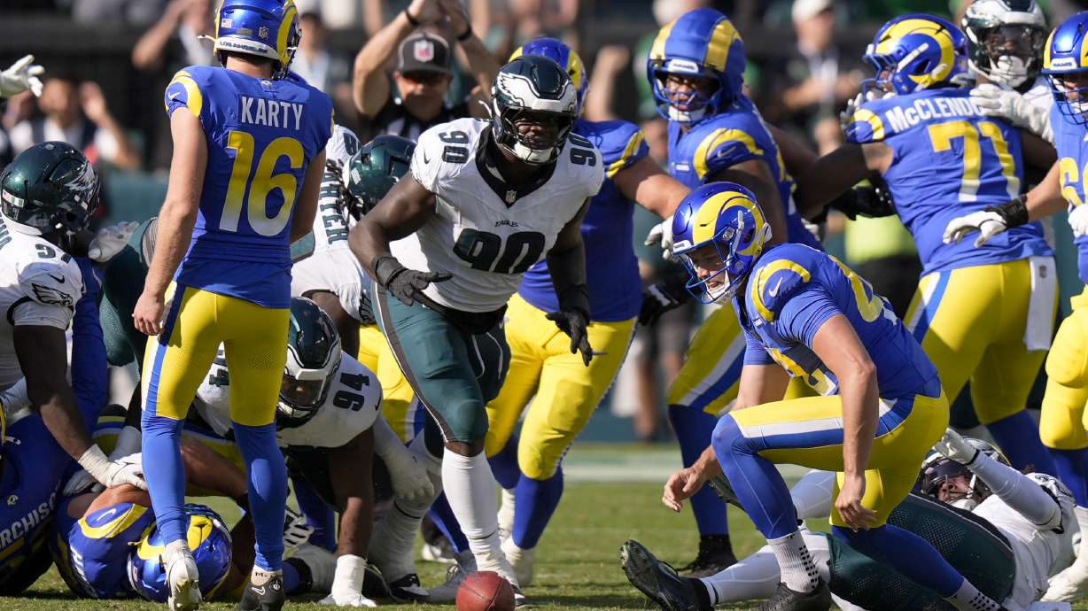 Philadelphia Eagles defensive tackle Jordan Davis (90) prepares to pick up the ball after blocking a field goal attempt by Los Angeles Rams kicker Joshua Karty (16) and run the ball back for a touchdown as time expires during the second half of an NFL football game against the Los Angeles Rams Sunday, Sept. 21, 2025, in Philadelphia.