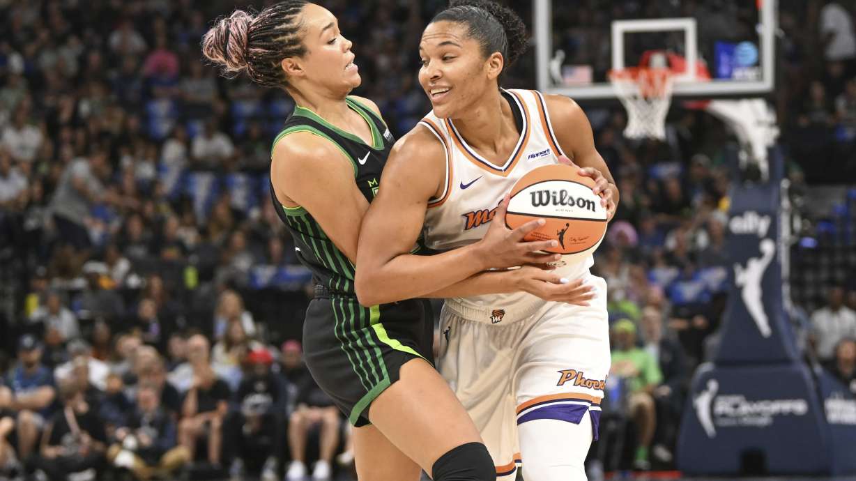 Phoenix Mercury forward Alyssa Thomas, right, tries to drive past Minnesota Lynx forward Napheesa Collier, left, during the first half of Game 1 of a WNBA basketball playoff semifinals series Sunday, Sept. 21, 2025, in Minneapolis.