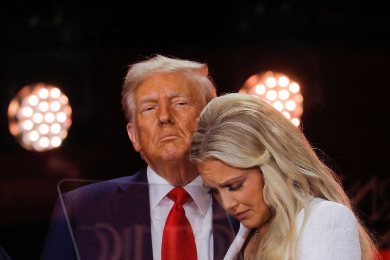 Erika Kirk, wife of slain conservative commentator Charlie Kirk and the new CEO of Turning Point USA, reacts next to President Donald Trump during a memorial service at State Farm Stadium, in Glendale, Arizona, Sunday.