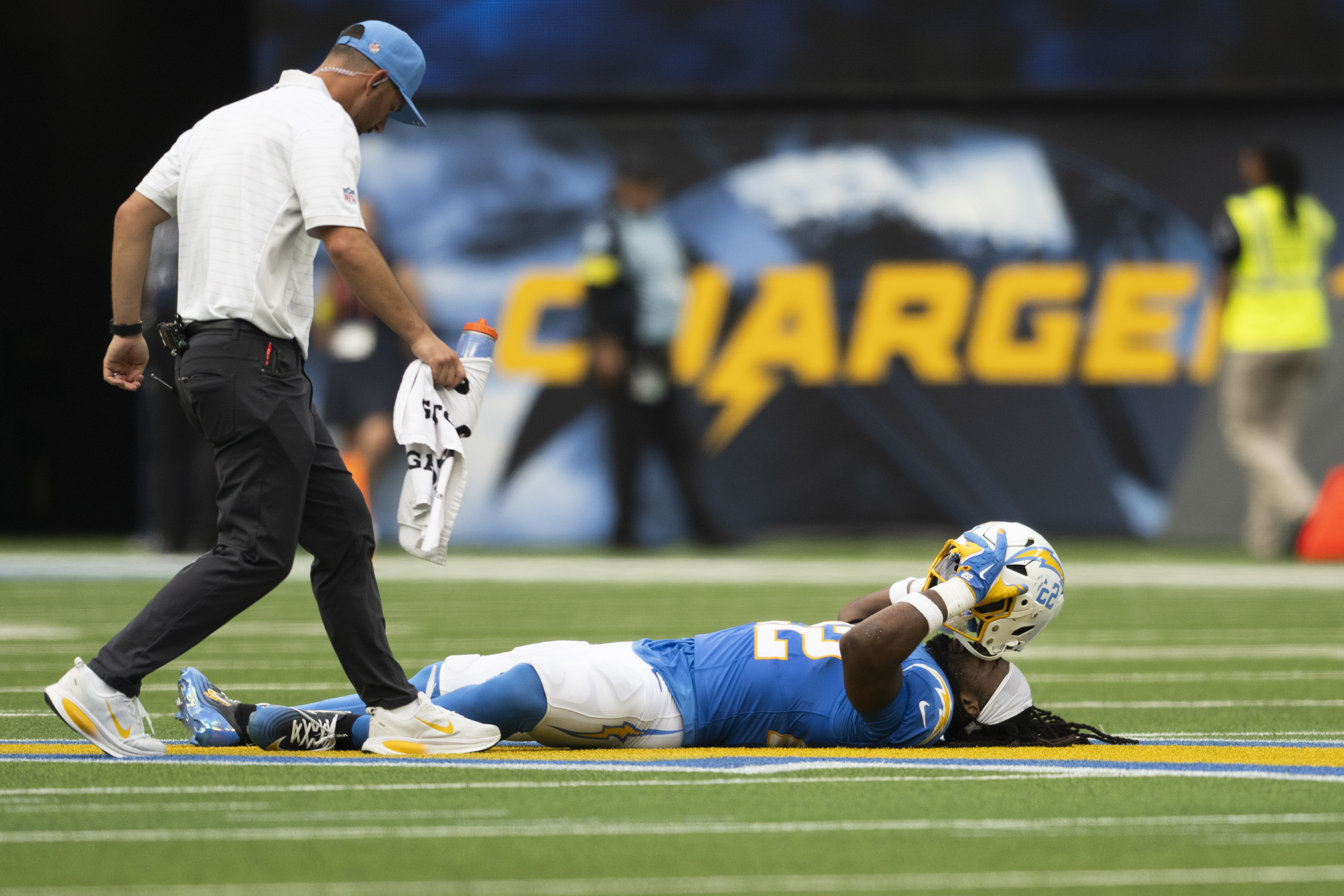 Los Angeles Chargers running back Najee Harris, right, lays on the ground after getting injured during an NFL football game against the Denver Broncos, Sunday, Sept. 21, 2025, in Inglewood, Calif. 