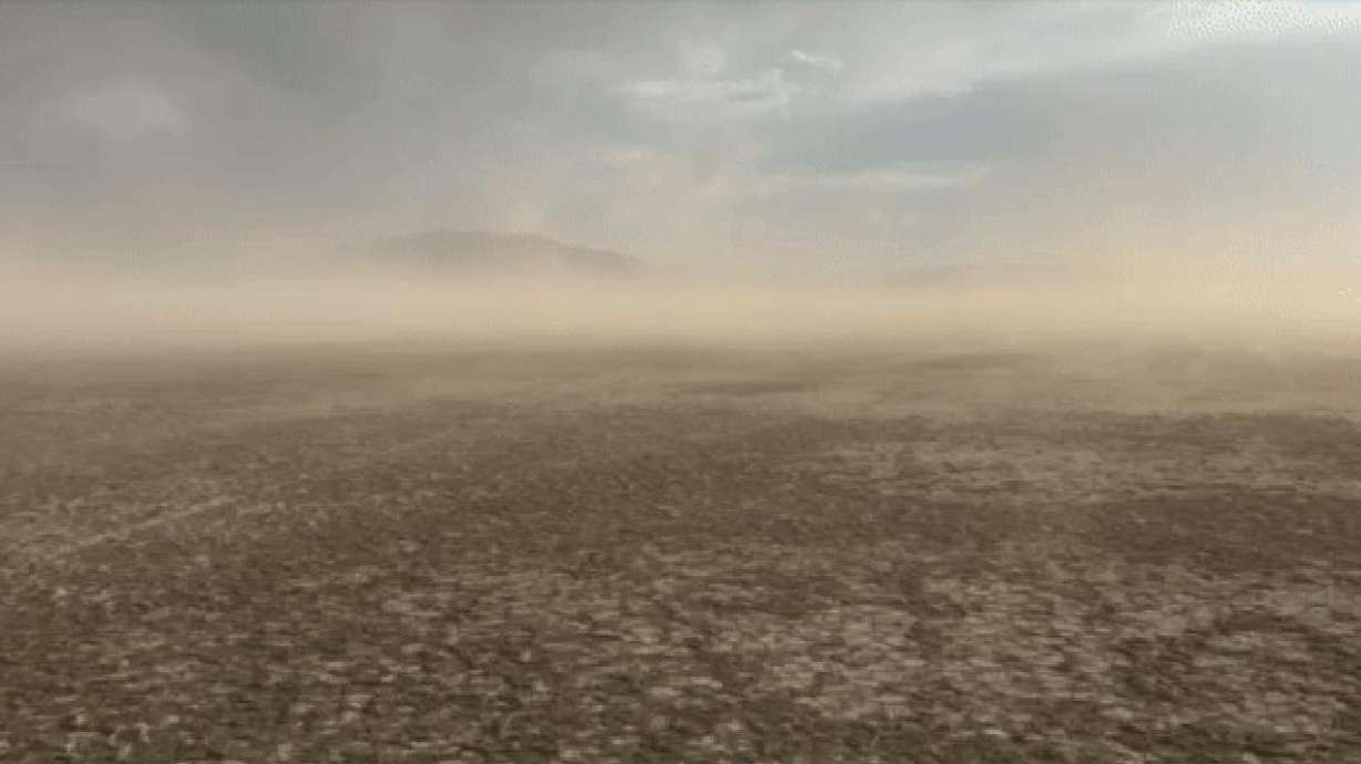 Dust blows off the drying playa at Farmington Bay on July 9, with Antelope Island in the background.