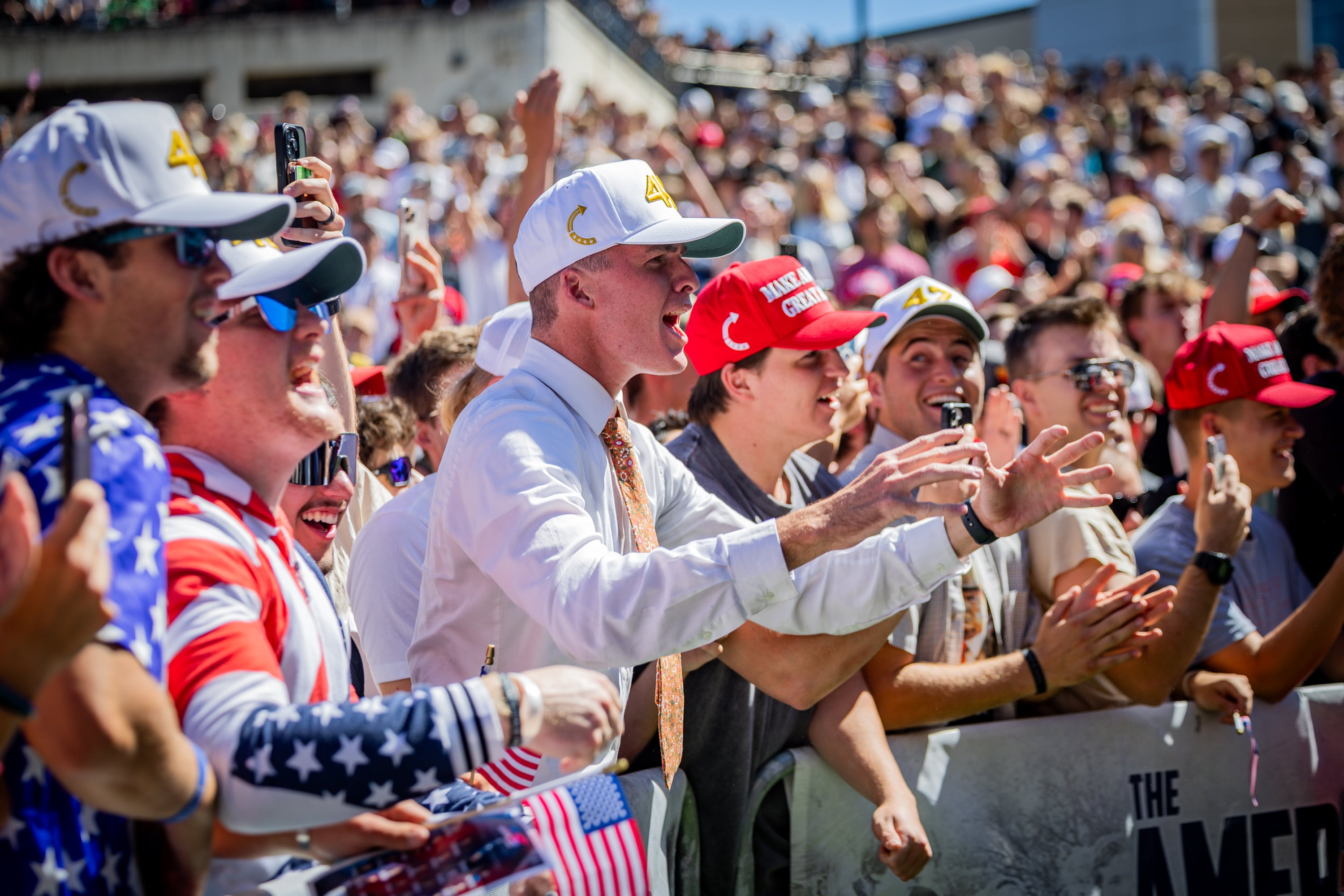 The crowd cheers as Charlie Kirk hands out hats before he is shot and killed at Utah Valley University in Orem on Sept. 10. About half of Utahns polled say they're less likely to attend political events now.