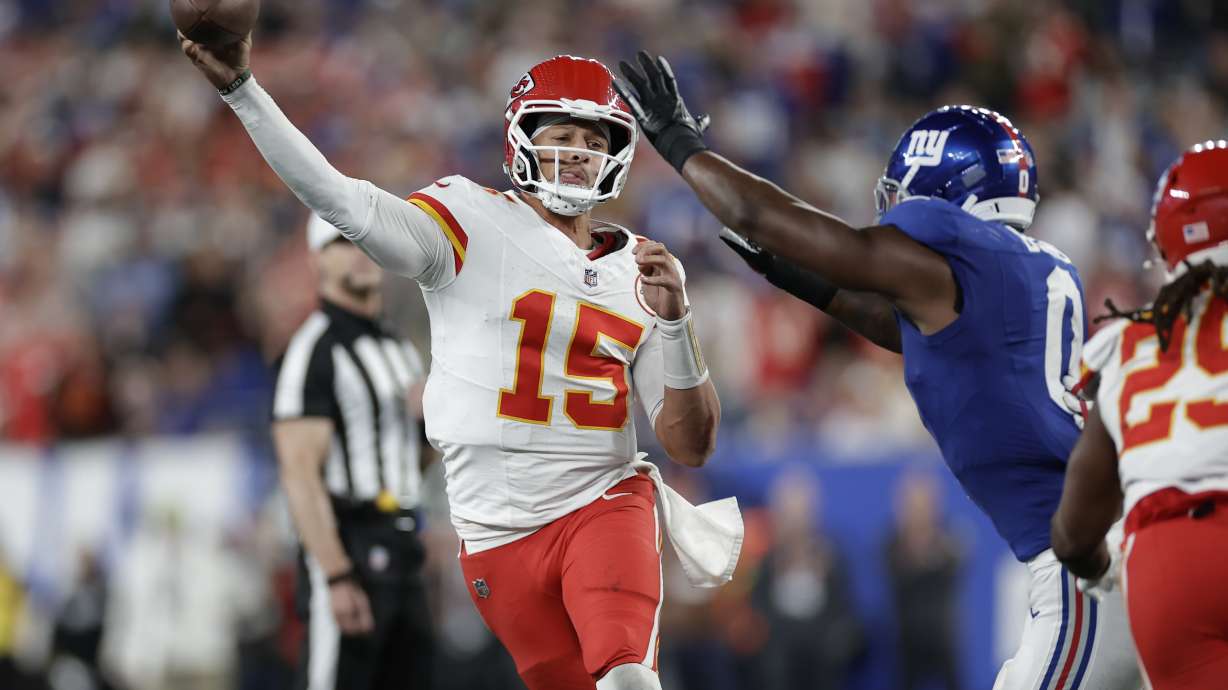 Kansas City Chiefs quarterback Patrick Mahomes (15) throws under pressure from New York Giants outside linebacker Brian Burns (0) during the first half of an NFL football game Sunday, Sept. 21, 2025, in East Rutherford, N.J.