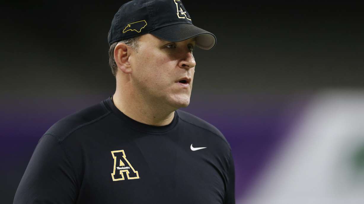 FILE - Appalachian State coach Shawn Clark watches players warm up before taking on UAB in the New Orleans Bowl NCAA college football game in New Orleans, on Dec. 21, 2019.