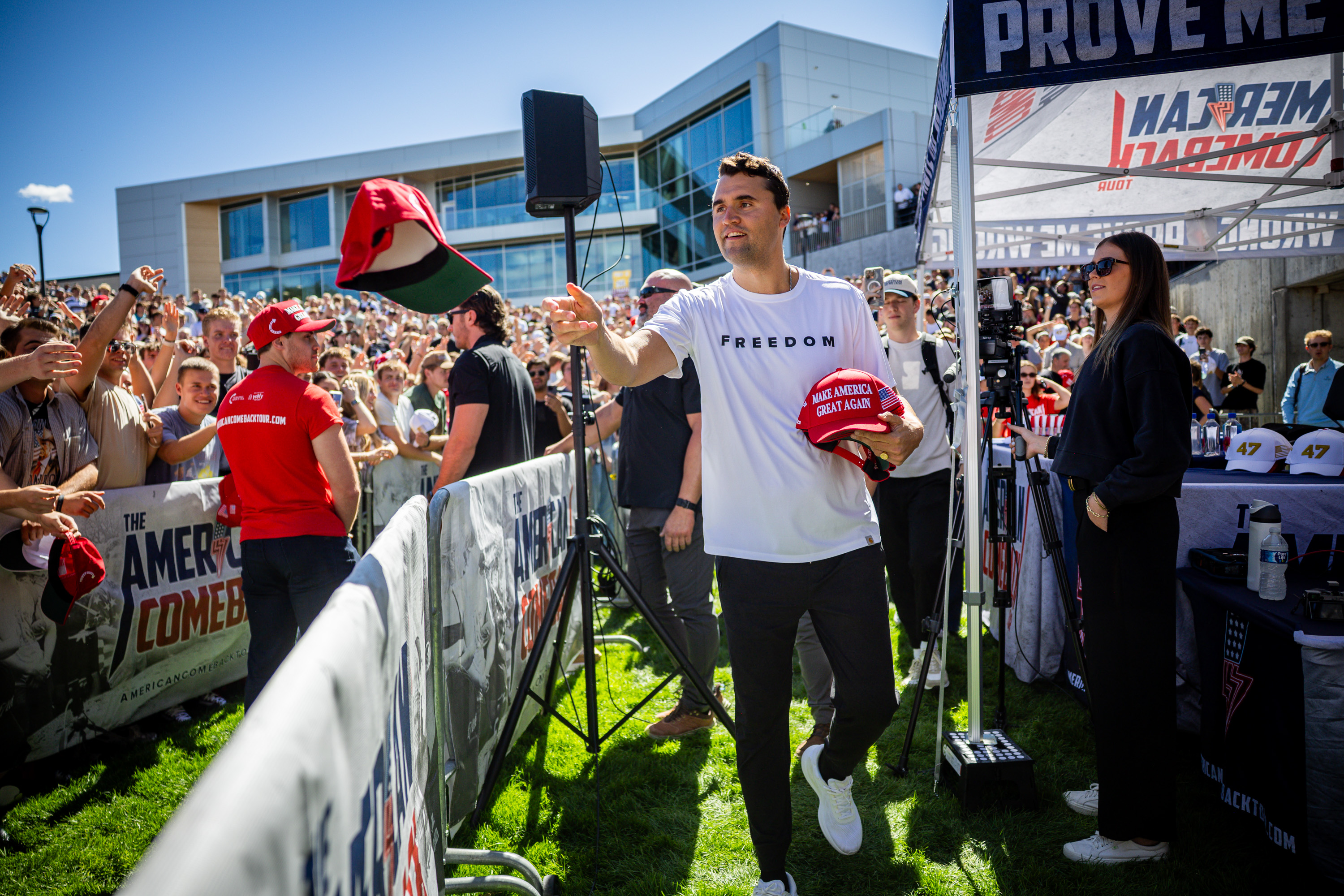 Charlie Kirk hands out hats before he was shot and killed during Turning Point USA’s visit to Utah Valley University in Orem Sept. 10. President Donald Trump awarded Kirk the Presidential Medal of Freedom Tuesday.