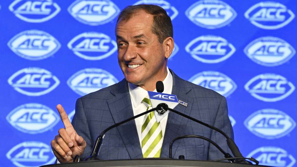 FILE - Atlantic Coast Conference commissioner Jim Phillips smiles during an NCAA college football news conference at the ACC media days, July 22, 2024, in Charlotte, N.C.