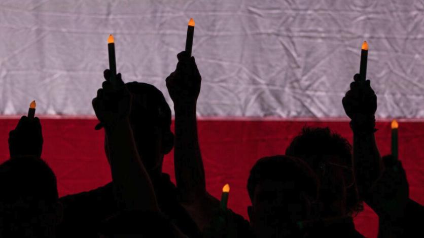 Representatives from Utah universities hold up candles during the Vigil for Unity at the UCCU Center at Utah Valley University in Orem on Friday. UVU officials have initiated what they call a comprehensive and independent review in response to an on-campus assassination.