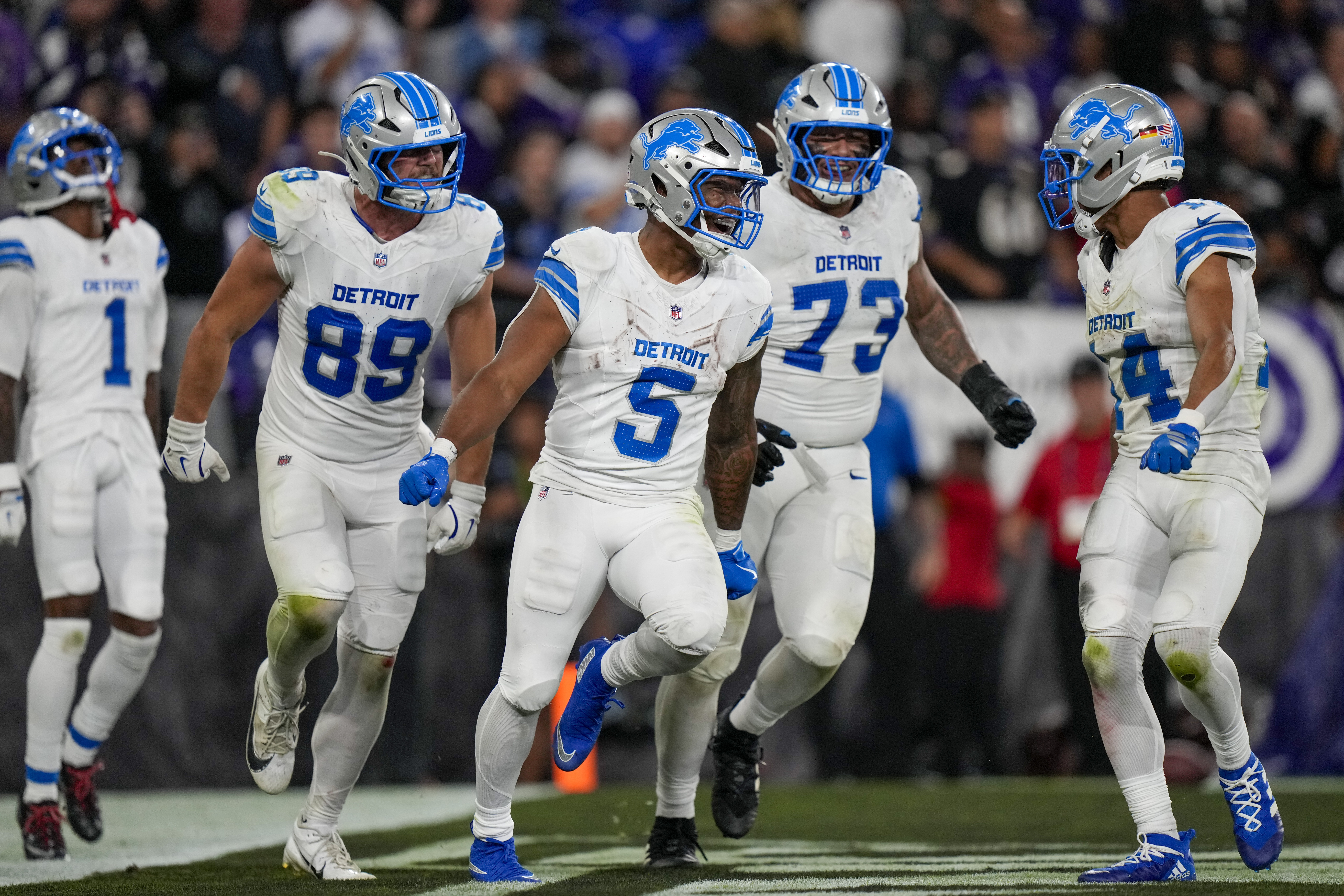 Detroit Lions running back David Montgomery (5) celebrates his touchdown run with teammates wide receiver Jameson Williams (1), tight end Brock Wright (89), guard Christian Mahogany (73) and wide receiver Amon-Ra St. Brown (14) during the second half of an NFL football game against the Baltimore Ravens Monday, Sept. 22, 2025, in Baltimore. 
