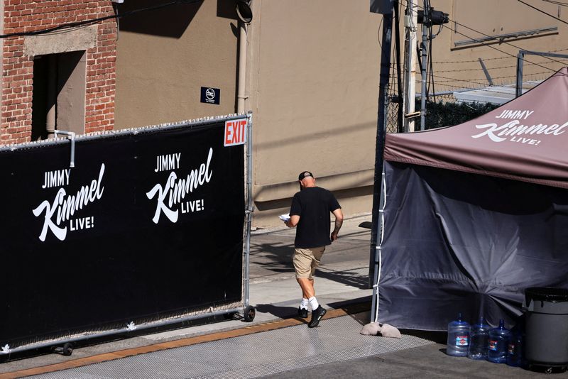 A person walks towards the theatre where "Jimmy Kimmel Live!" was recorded for broadcast following announcement by Disney that "Jimmy Kimmel Live" will return to its ABC network lineup on Tuesday, in Los Angeles, Monday. 
