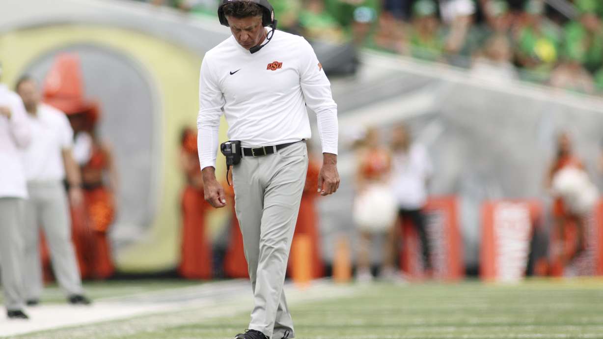 Oklahoma State head coach Mike Gundy walks on the field during the first half of an NCAA college football game, Saturday, Sept. 6, 2025, in Eugene, Ore.