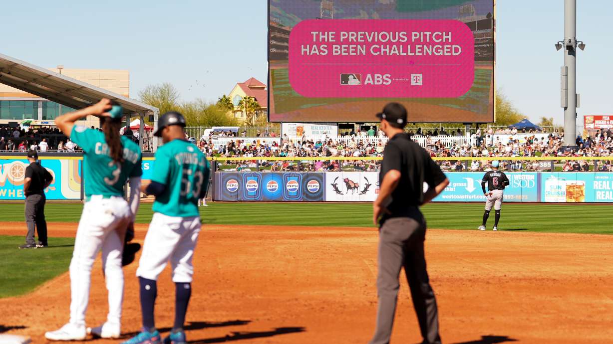 FILE - An outfield screen shows a graphic indicating Seattle Mariners' Julio Rodriguez challenged a pitch call, initiating a review with the automated ball-strike challenge system, in the third inning against the Arizona Diamondbacks during a spring training baseball game Sunday, Feb. 23, 2025, in Peoria, Ariz.
