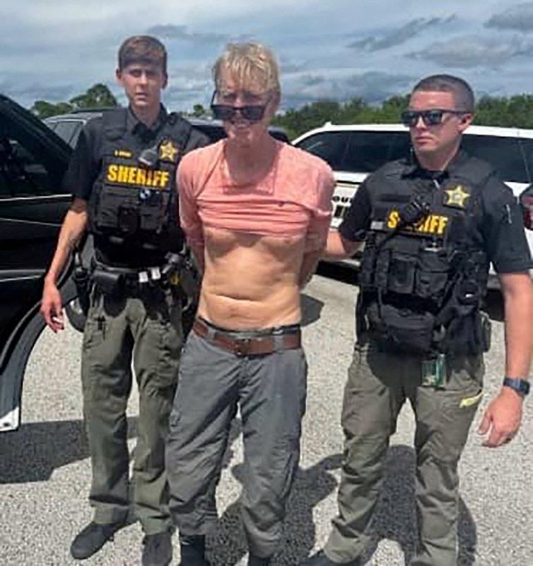 Ryan W. Routh, suspected of attempting to assassinate President Donald Trump, stands handcuffed near Palm City, Fla., Sept. 15, 2024. Routh was found guilty Tuesday of the attempted assassination.