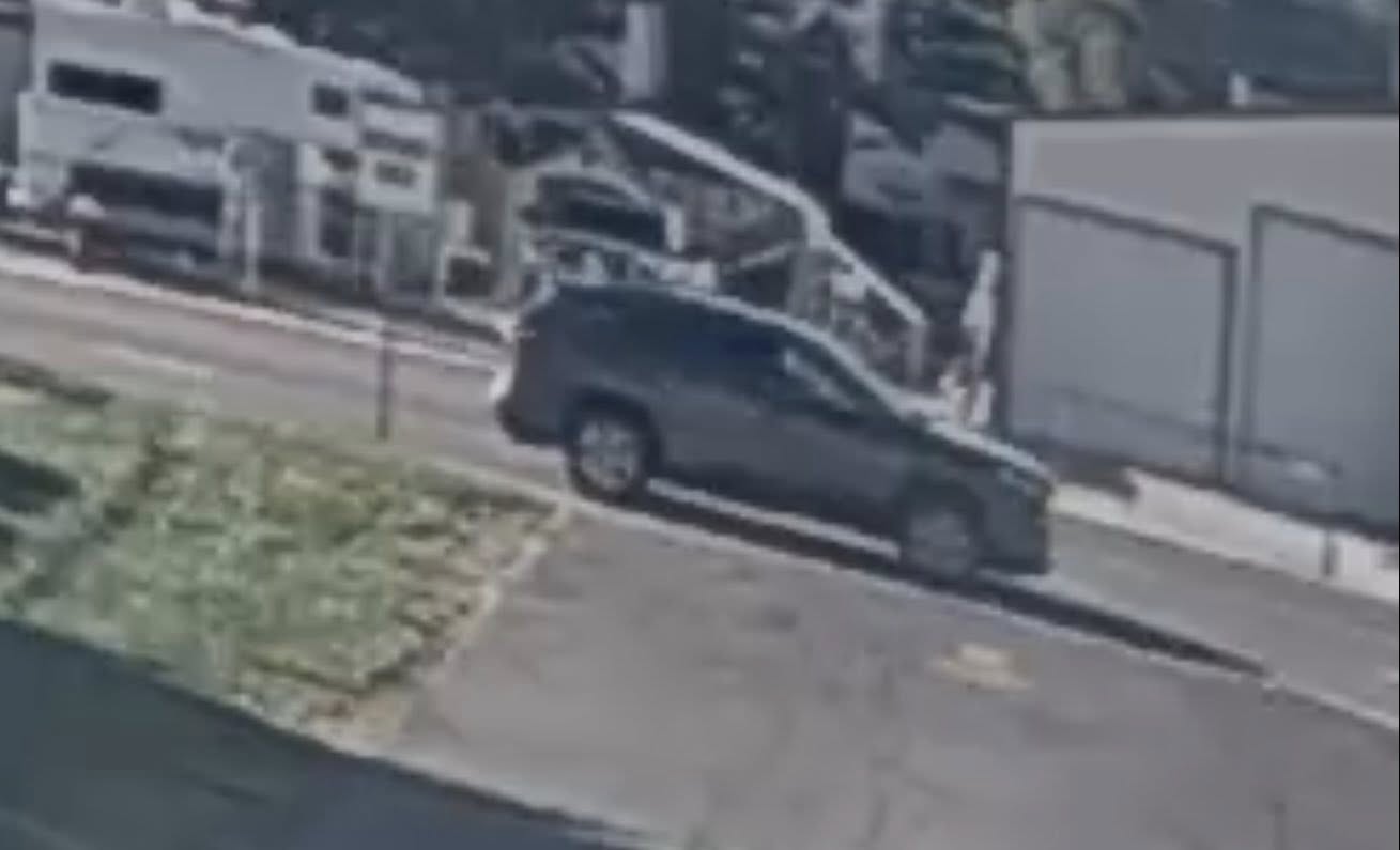 An image of a dark charcoal compact SUV that police say hit a woman in the front yard of a Roy home and then drove away on Tuesday morning. The driver has since turned himself or herself in.