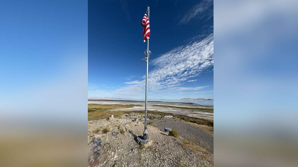 An American flag flies atop Black Rock in Tooele County on Friday. State land managers say the flagpole was illegally constructed atop the historic site last week.