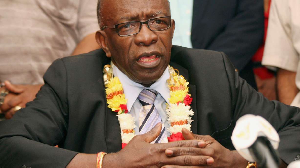 FILE - Suspended FIFA executive Jack Warner gestures during a news conference at the airport in Port-of-Spain, Trinidad and Tobago, June 2, 2011.