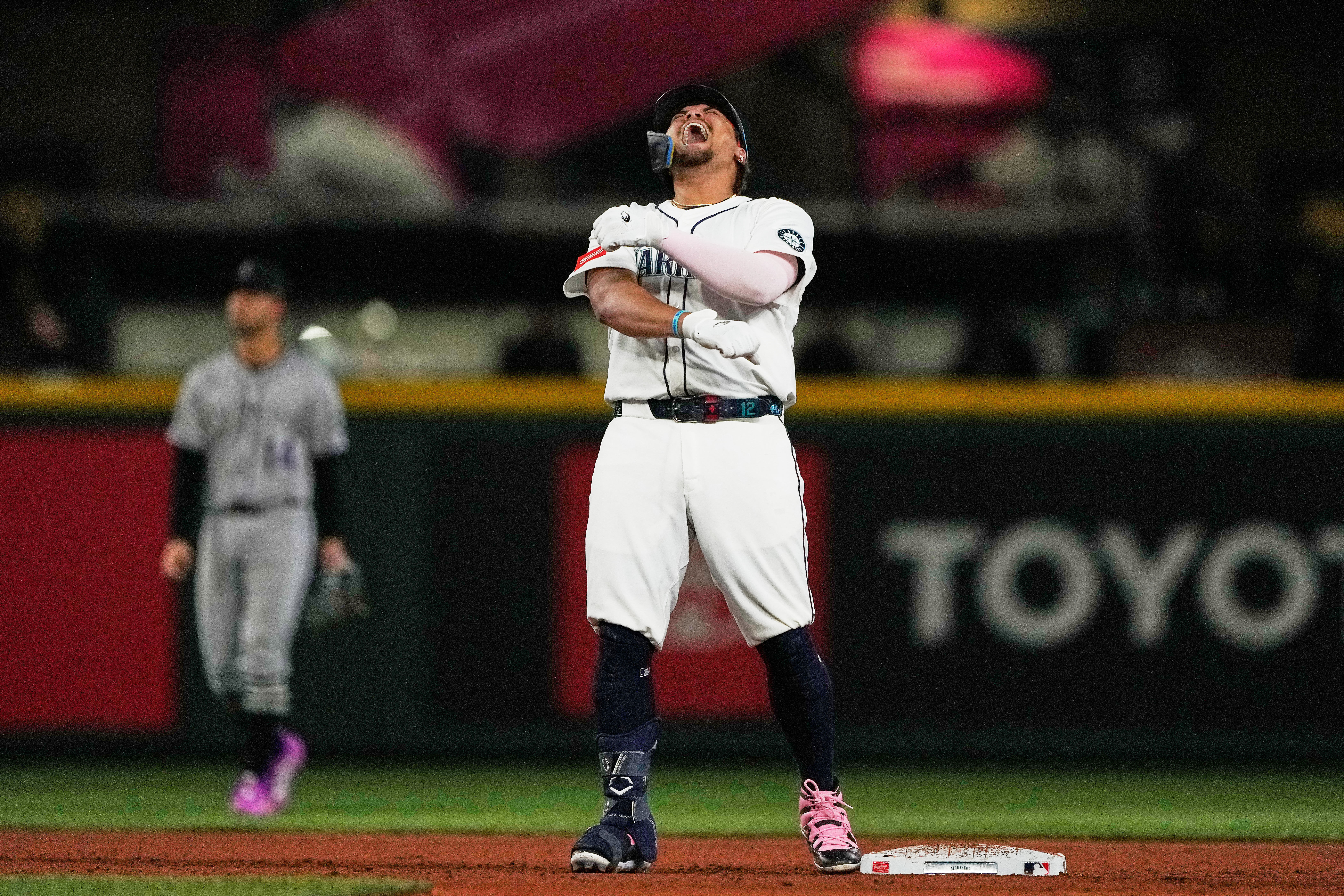 Seattle Mariners' Josh Naylor reacts after hitting a three-run double that scored Luke Raley, J.P. Crawford, and Julio Rodriguez during the eighth inning of a baseball game against the Colorado Rockies, Tuesday, Sept. 23, 2025, in Seattle. 