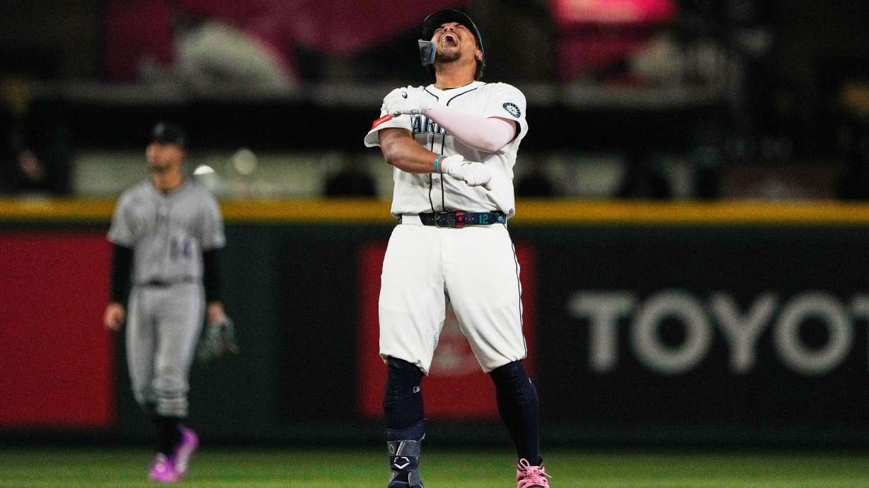 Seattle Mariners' Josh Naylor reacts after hitting a three-run double that scored Luke Raley, J.P. Crawford, and Julio Rodriguez during the eighth inning of a baseball game against the Colorado Rockies, Tuesday, Sept. 23, 2025, in Seattle.