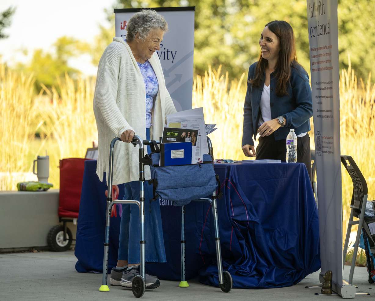Alice Neff talks with Sara Mathews, an initiative manager of health, promotion and wellness, with Intermountain Health as Salt Lake County Falls Prevention Coalition hosts Strong & Steady, a free community event highlighting ways to prevent falls, at the Wheeler Farm Outdoor Education Center in Murray on Tuesday.