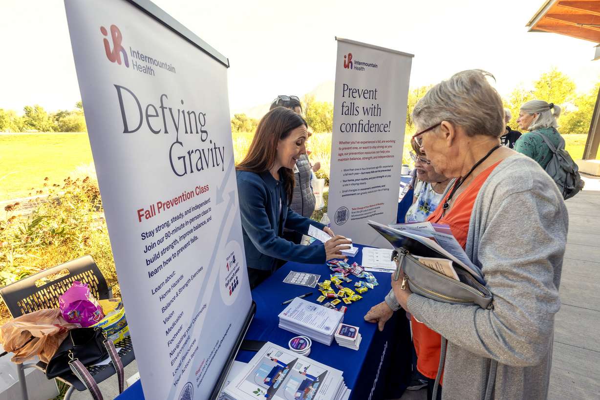 Sara Mathews, initiative manager of health, promotion and wellness with Intermountain Health, and Yvette Pierce, trauma program manager at Intermountain Health, talk with Janet Whitemore and Sally Smith as Salt Lake County Falls Prevention Coalition hosts Strong and Steady, a free community event highlighting ways to prevent falls, at the Wheeler Farm Outdoor Education Center in Murray on Tuesday.