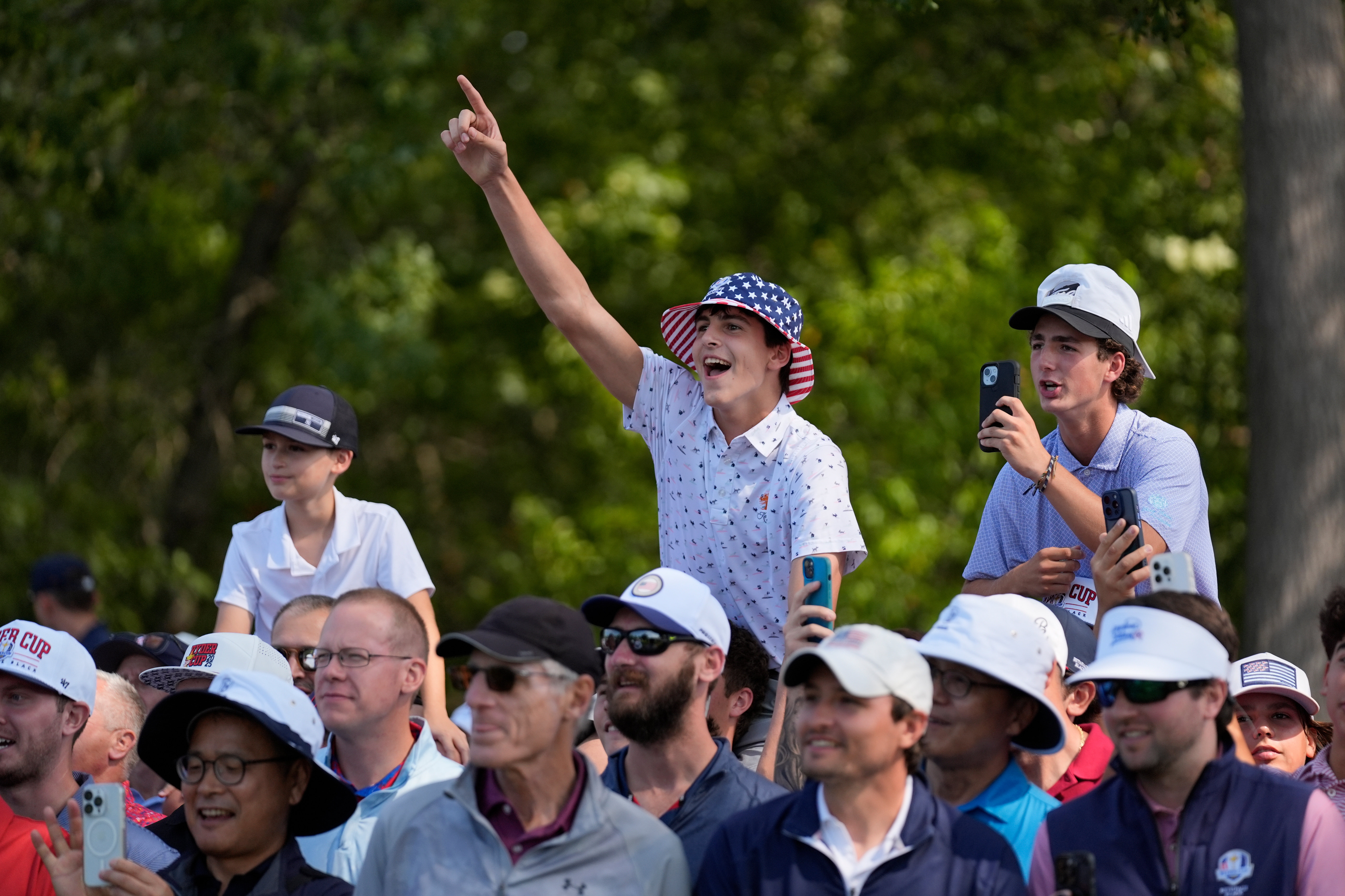 Fans react during a practice round for the Ryder Cup golf tournament, Tuesday, Sept. 23, 2025, in Farmingdale, N.Y., at Bethpage State Park's Black Course.