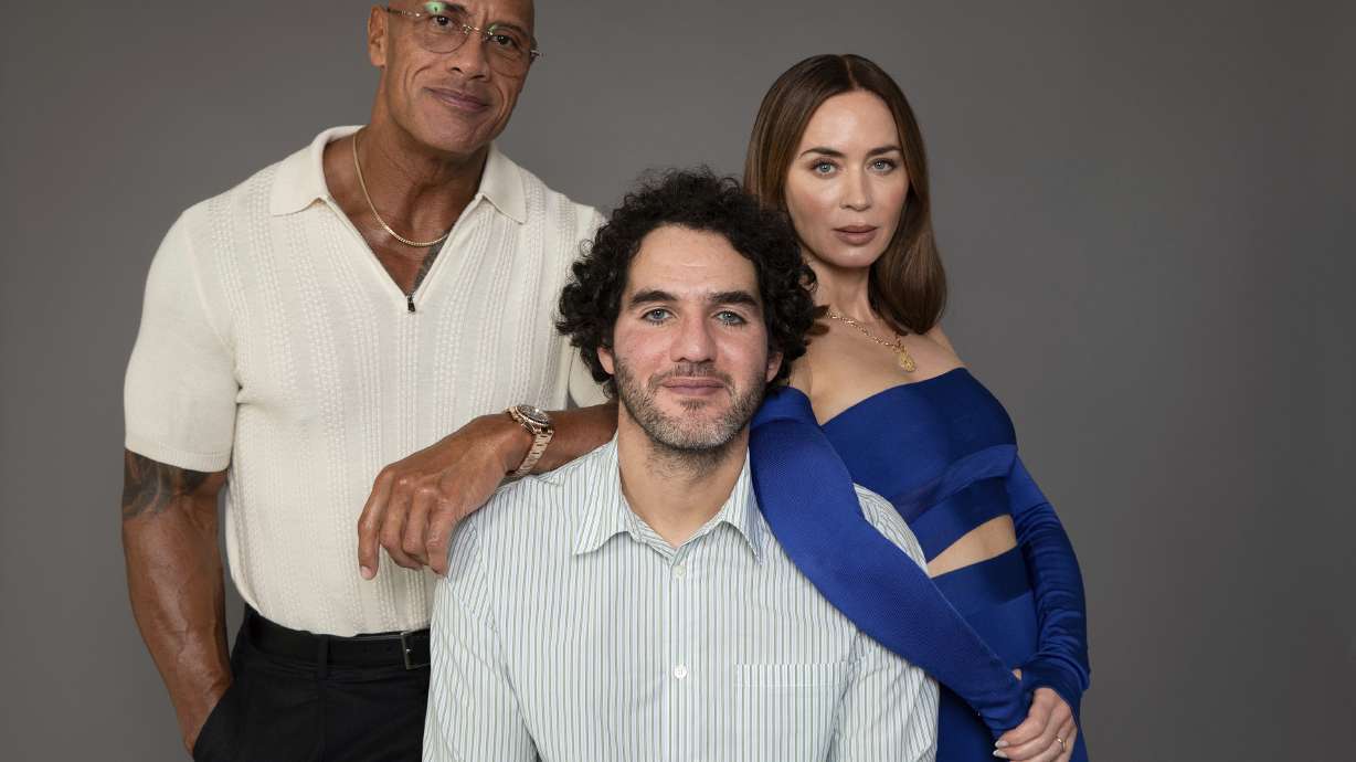 Dwayne Johnson, from left, Benny Safdie and Emily Blunt pose to promote their film "The Smashing Machine" on Friday, Sept. 12, 2025, in Los Angeles.