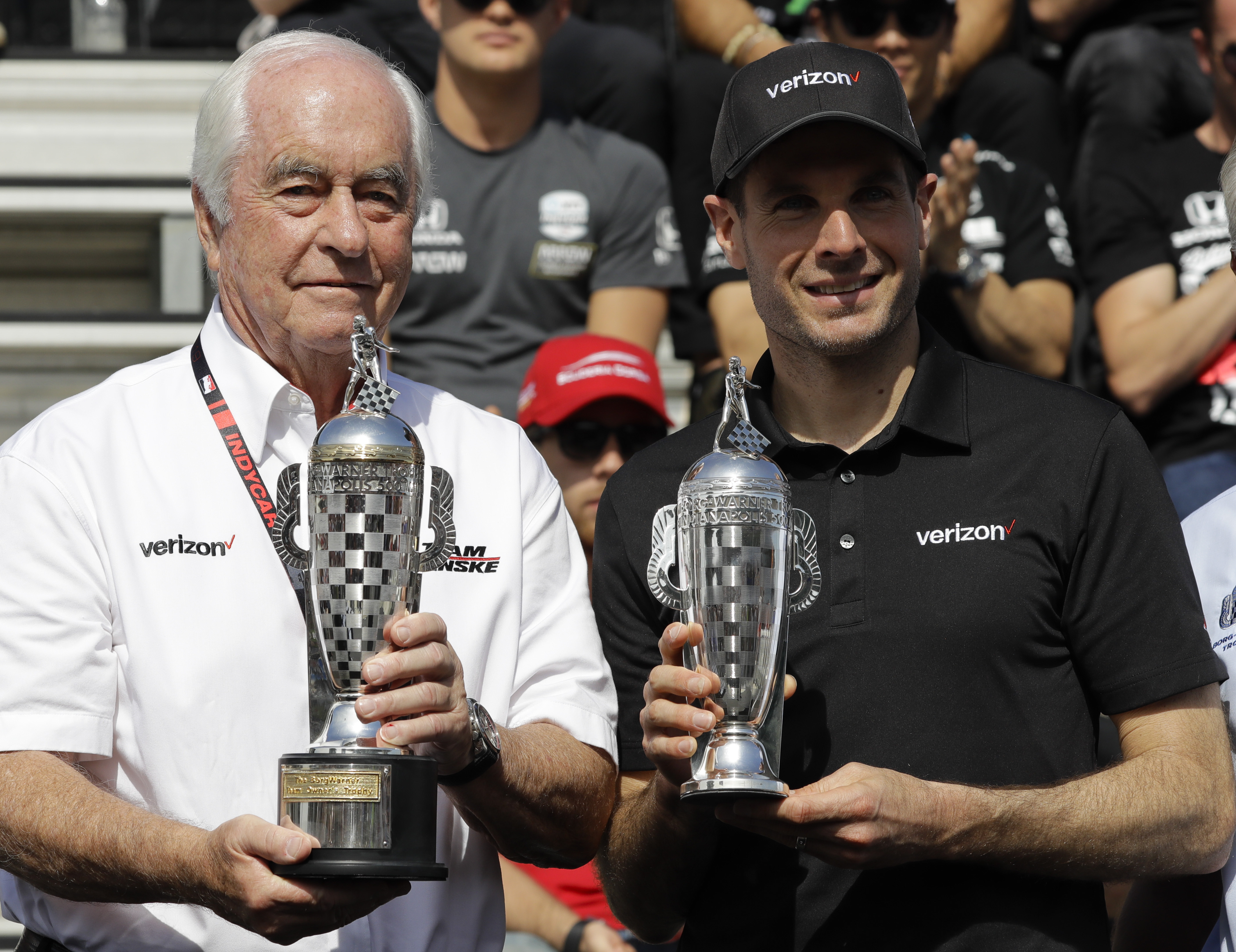 FILE - Car owner Roger Penske, left, and driver Will Power, of Australia, receive their "Baby Borg" trophies for winning last years race during the drivers meeting for the Indianapolis 500 IndyCar auto race at Indianapolis Motor Speedway, Saturday, May 25, 2019, in Indianapolis.