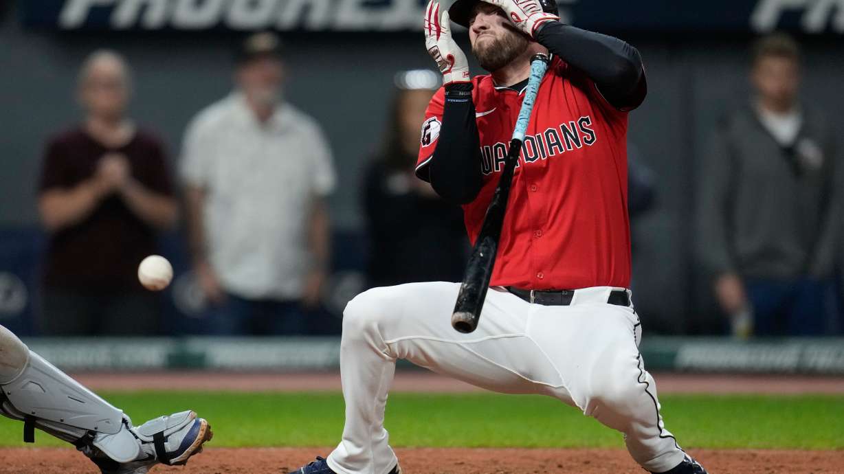 CORRECTION CORRECTS HITTING ON THE FACE BY PITCH - Cleveland Guardians' David Fry falls back after being hit in the face by a pitch in the sixth inning of a baseball game against the Detroit Tigers in Cleveland, Tuesday, Sept. 23, 2025.
