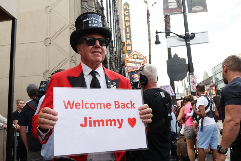 Gregg Donavan holds a sign welcoming Jimmy Kimmel back to TV in Los Angeles, Tuesday. Sinclair and Nexstar Media both announced Friday that "Jimmy Kimmel Live!" would return to their airwaves following a brief boycott.