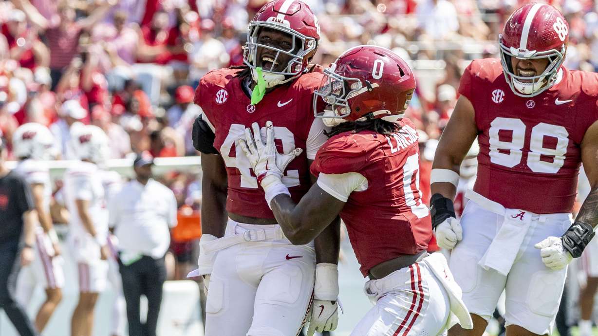Alabama linebacker Yhonzae Pierre (42) celebrates a sack with Alabama linebacker Deontae Lawson (0) during the second half of an NCAA college football game against Wisconsin, Saturday, Sept. 13, 2025, in Tuscaloosa, Ala.