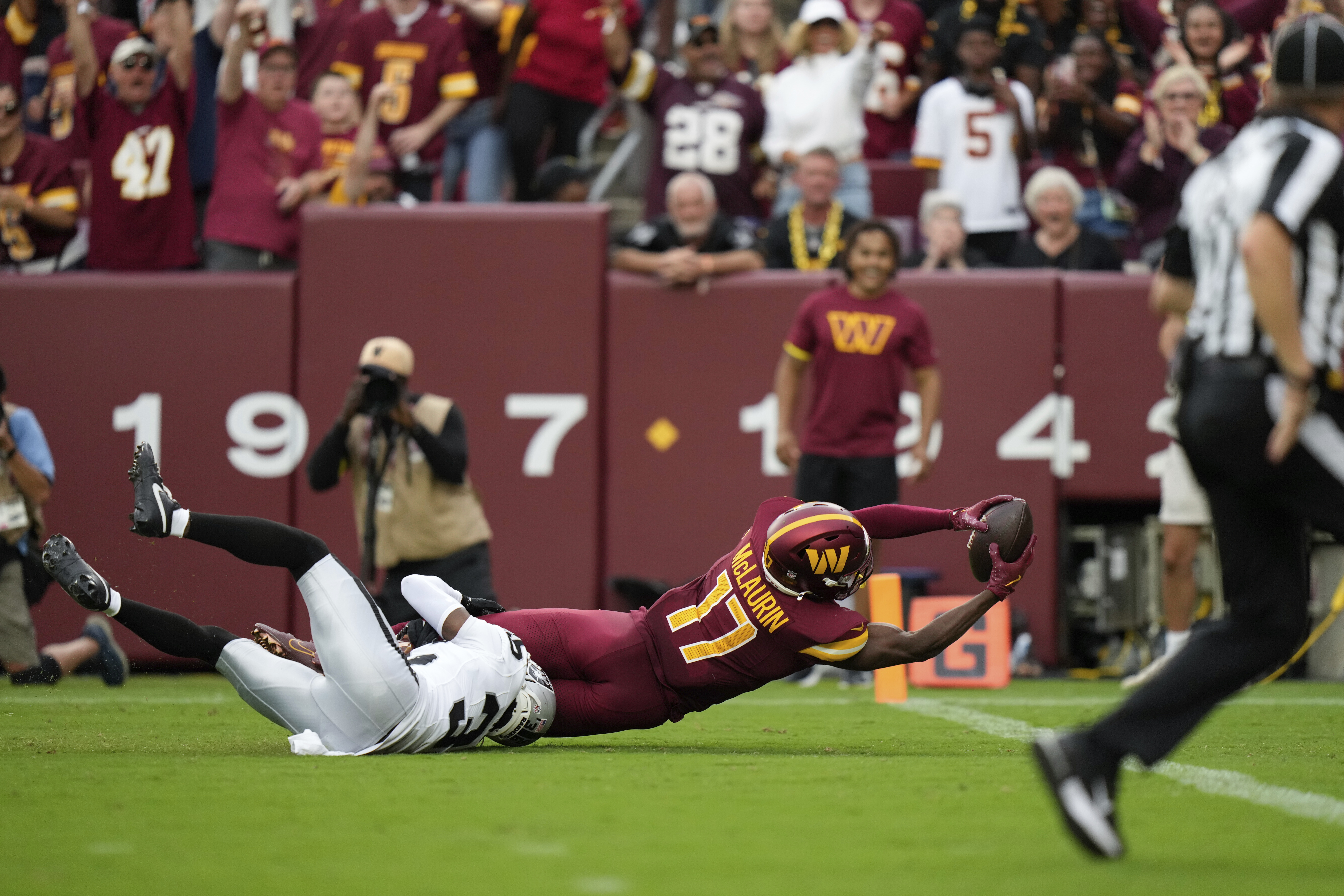 Washington Commanders wide receiver Terry McLaurin (17) is brought down by Las Vegas Raiders cornerback Kyu Blu Kelly (36) during the second half of NFL football game Sunday, Sept. 21, 2025, in Landover, Md. 