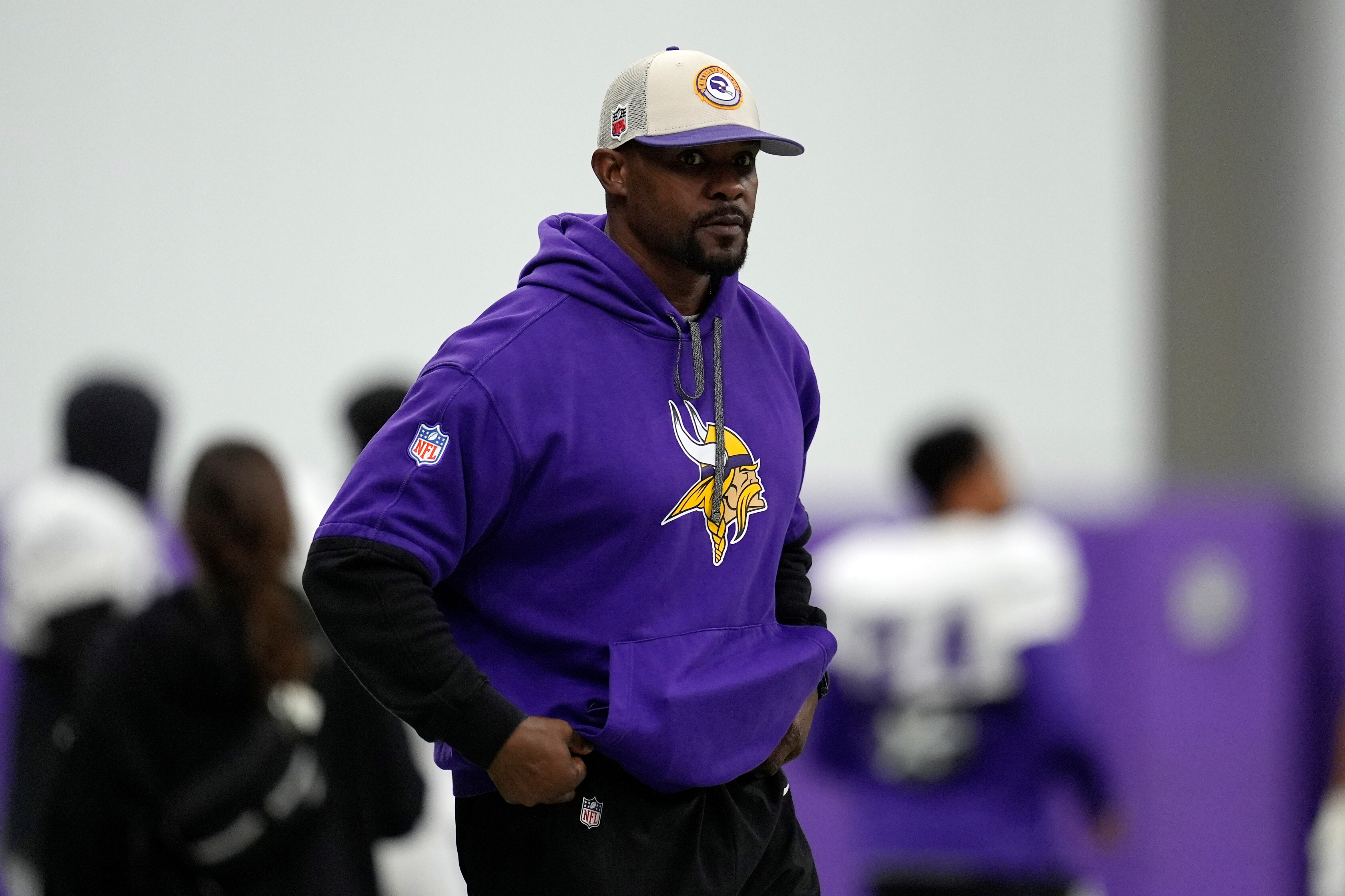 FILE - Minnesota Vikings defensive coordinator Brian Flores stands on the field during an NFL football workout in Eagan, Minn., Oct. 30, 2024. 