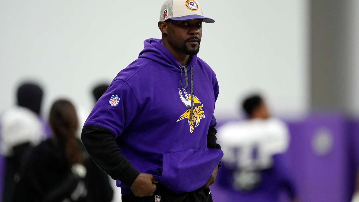 FILE - Minnesota Vikings defensive coordinator Brian Flores stands on the field during an NFL football workout in Eagan, Minn., Oct. 30, 2024.