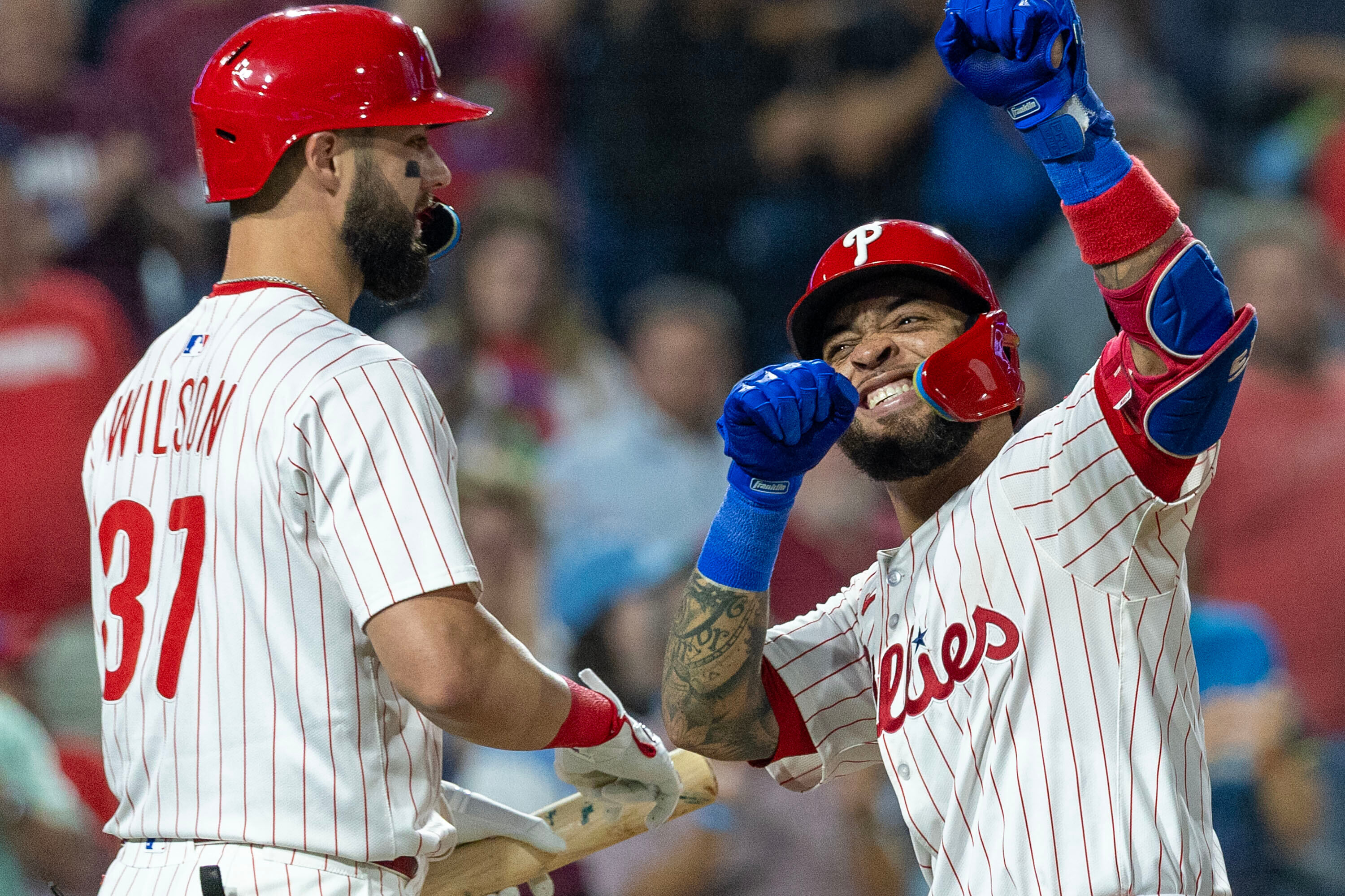 Philadelphia Phillies' Edmundo Sosa, right, celebrates with Weston Wilson (37) after hitting a two run homer in the fifth inning of a baseball game against the Miami Marlins, Wednesday, Sept. 24, 2025, in Philadelphia. 