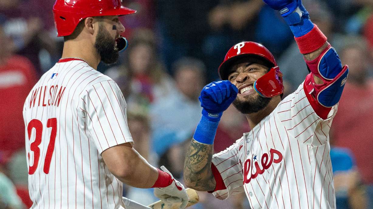 Philadelphia Phillies' Edmundo Sosa, right, celebrates with Weston Wilson (37) after hitting a two run homer in the fifth inning of a baseball game against the Miami Marlins, Wednesday, Sept. 24, 2025, in Philadelphia.