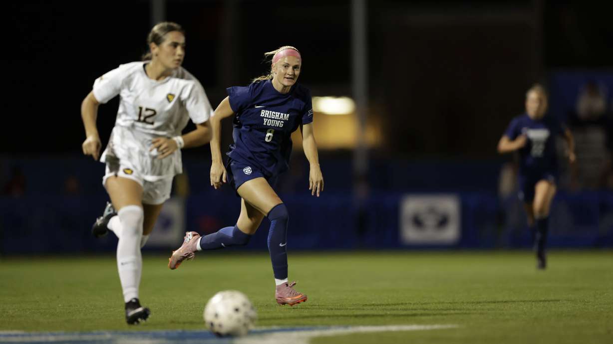 West Virginia's Olivia Shertzer (12) dribbles the ball away from BYU's Mika Krommenhoek during the Mountaineers' 3-2 win over the 16th-ranked Cougars in a Big 12 women's soccer match, Wednesday, Sept. 24, 2025 at South Field in Provo, Utah.