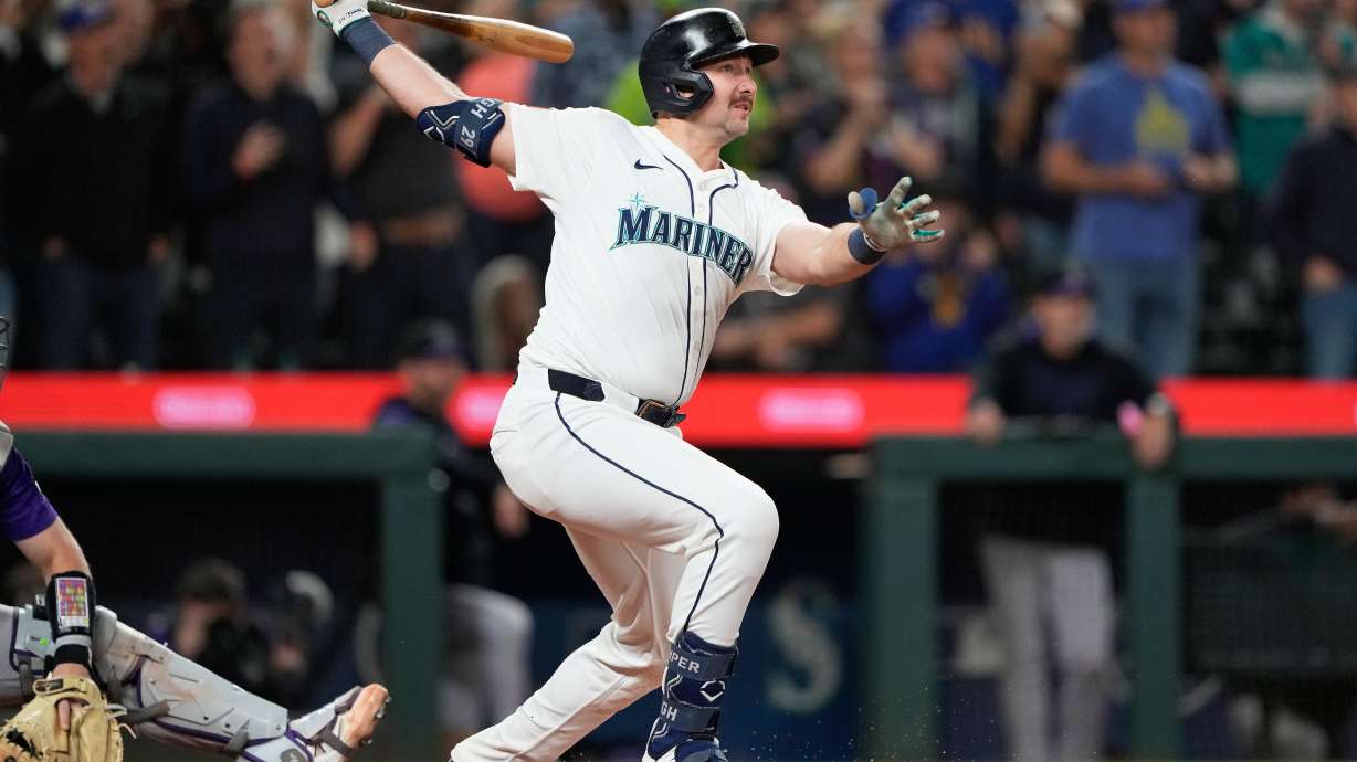 Seattle Mariners' Cal Raleigh watches his 60th home run during the eighth inning of a baseball game against the Colorado Rockies, Wednesday, Sept. 24, 2025, in Seattle.