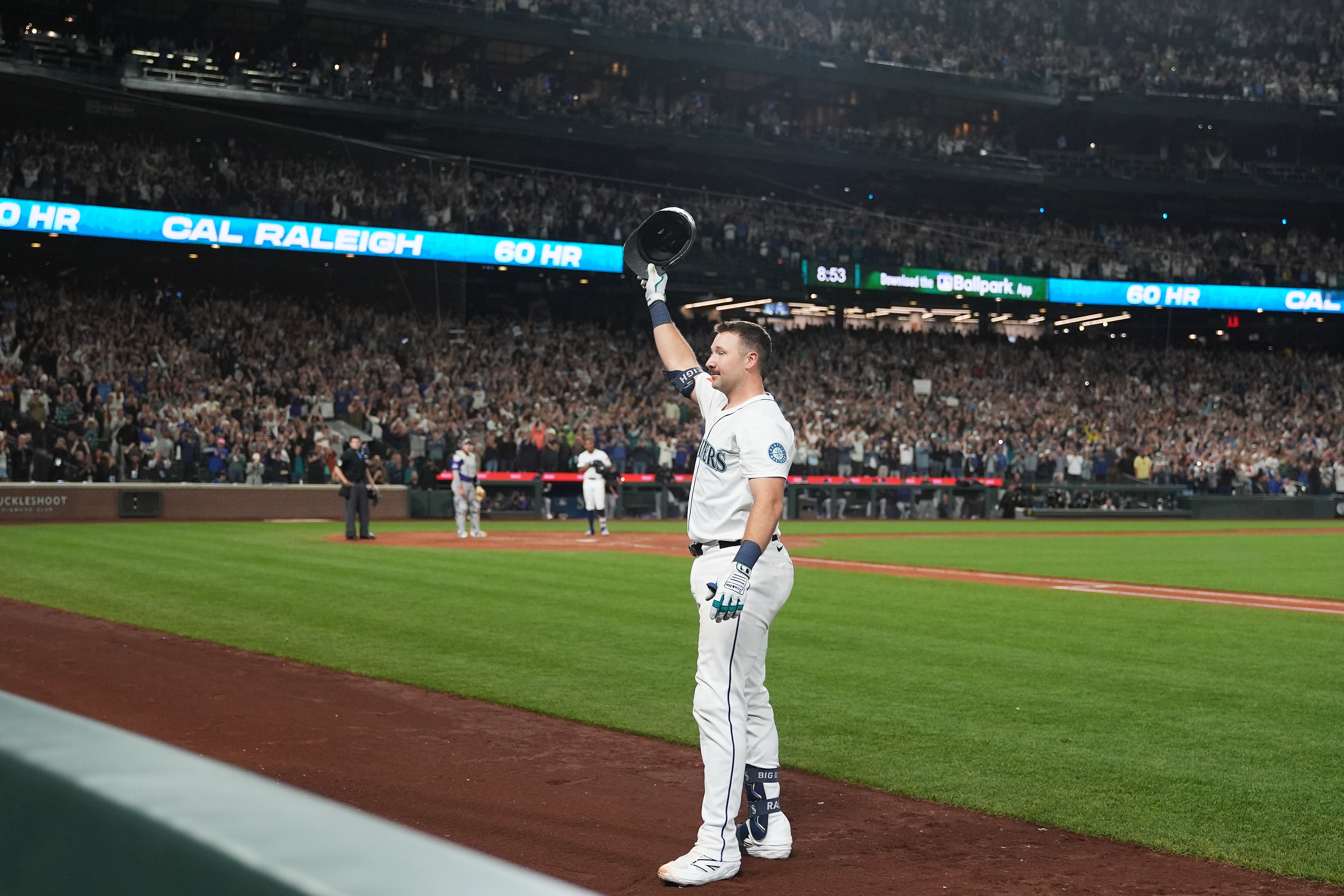 Seattle Mariners' Cal Raleigh waves to the crowd after hitting his 60th home run during the eighth inning of a baseball game against the Colorado Rockies, Wednesday, Sept. 24, 2025, in Seattle. 