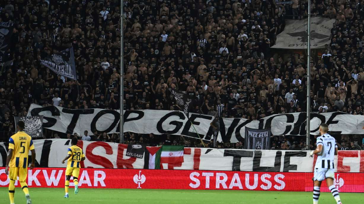 PAOK's fans display a banner that reads "stop genocide" during the Europa League soccer match between PAOK and Maccabi Tel Aviv at Toumpa stadium, in Thessaloniki, Greece, Wednesday, Sept. 24, 2025.